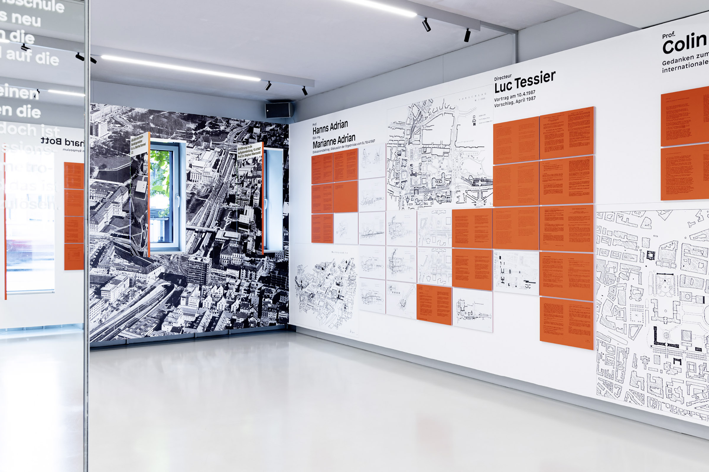 The drafts by the renowed architects, next to each other. The concepts and the graphics were separatedly printed on the wall and on red paper and mounted to the wall