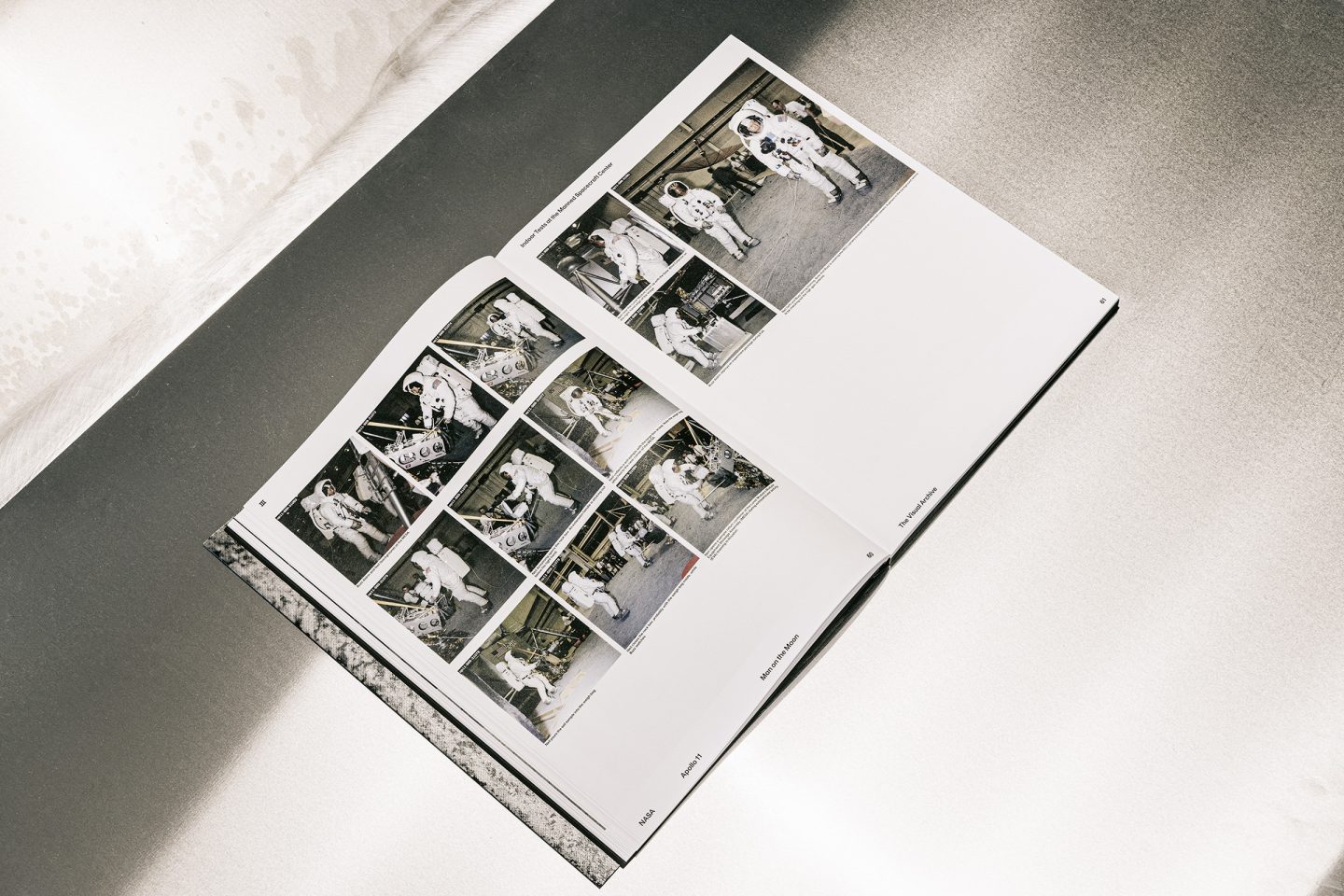 Large-format book spread with astronaut training photographs