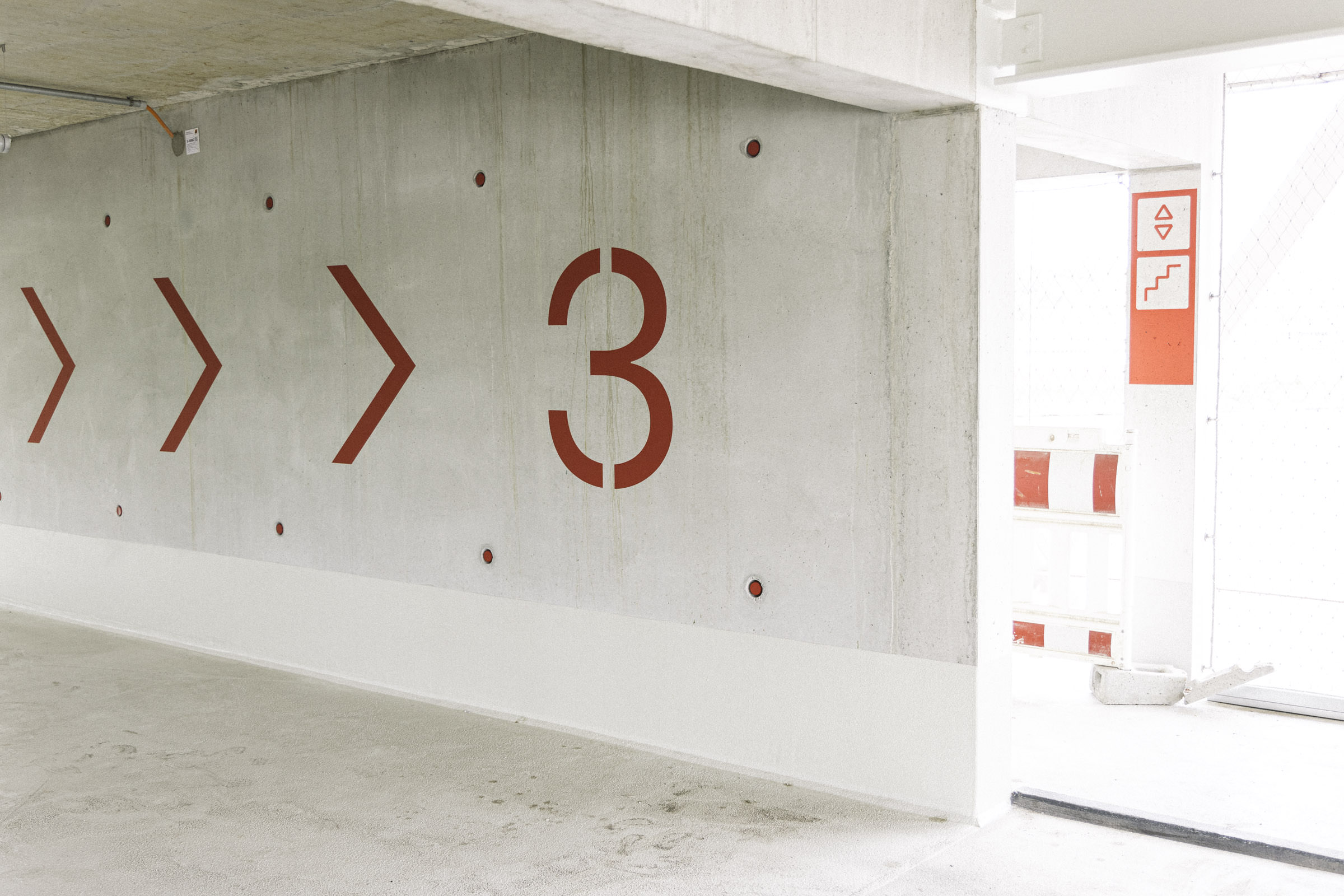 Big stencil arrows and letters are essential elements of the wayfinding