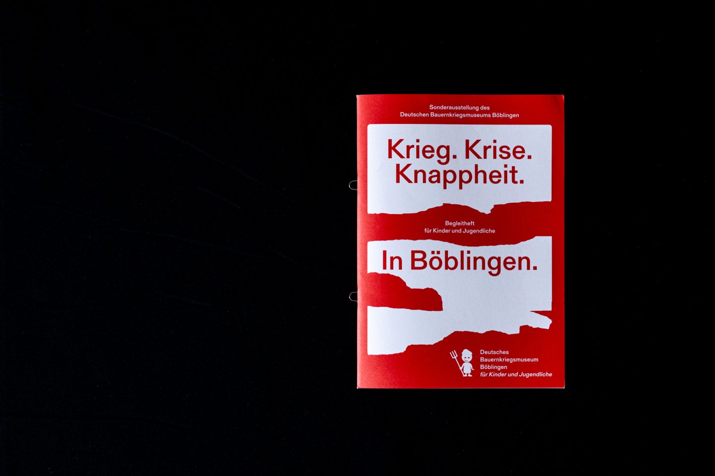 Children’s brochure for War. Crisis. Scarcity. In Böblingen on black background.