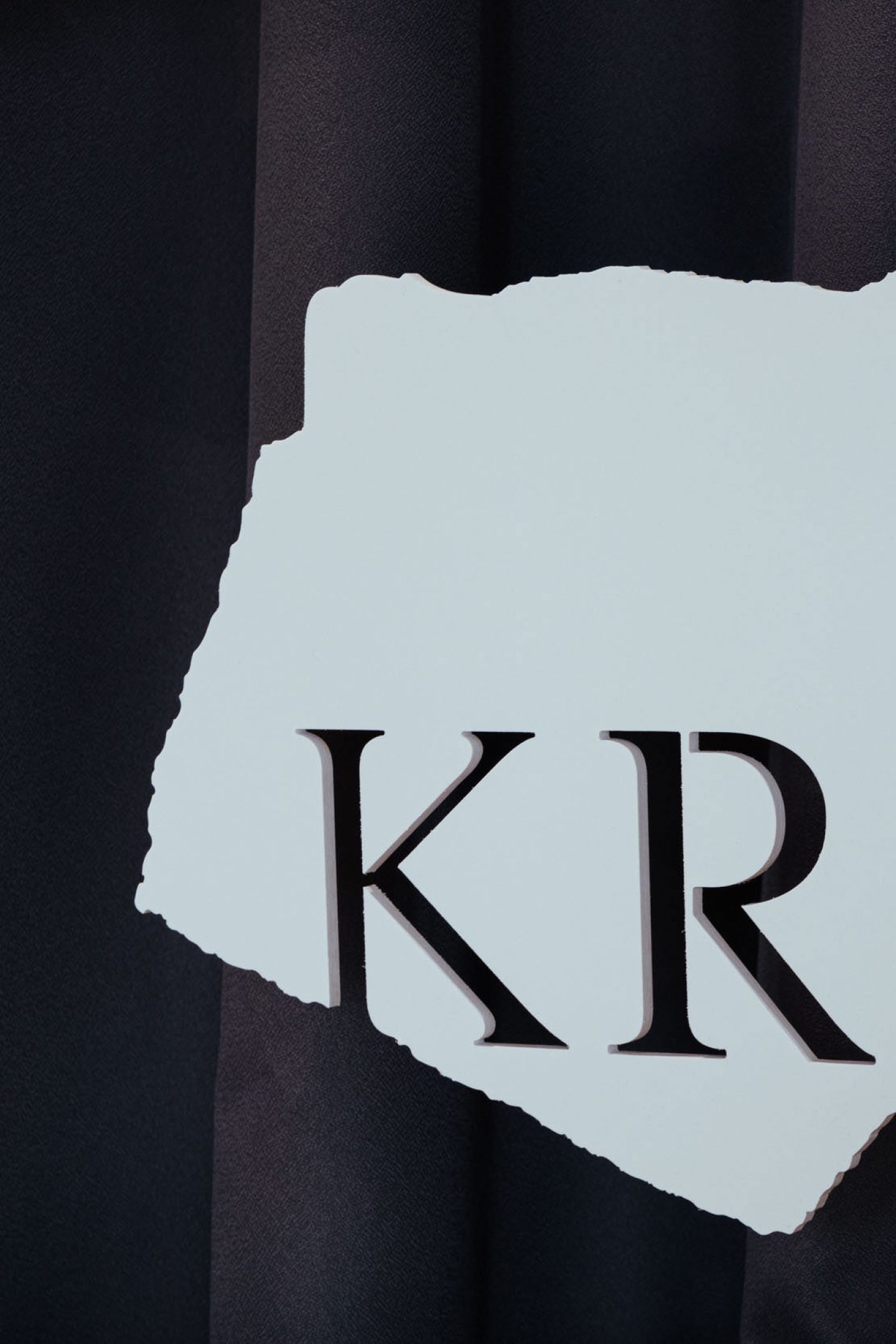 Detail of torn-paper typography used in the exhibition identity for War. Crisis. Scarcity.