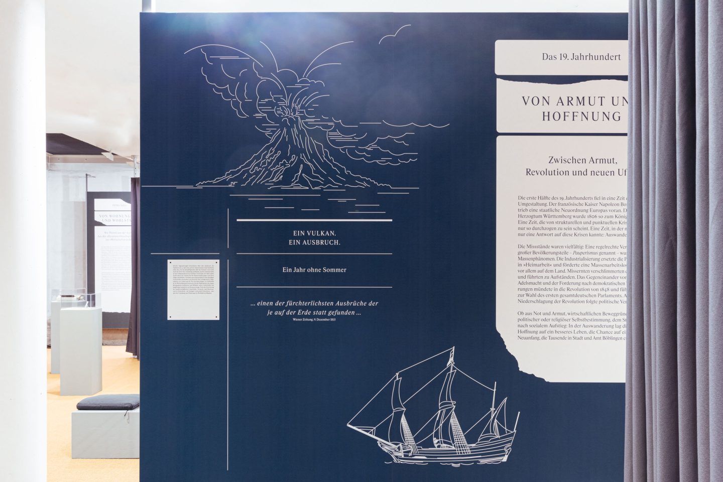 Illustrated exhibition wall with volcano and ship graphics in the historical museum exhibition design.