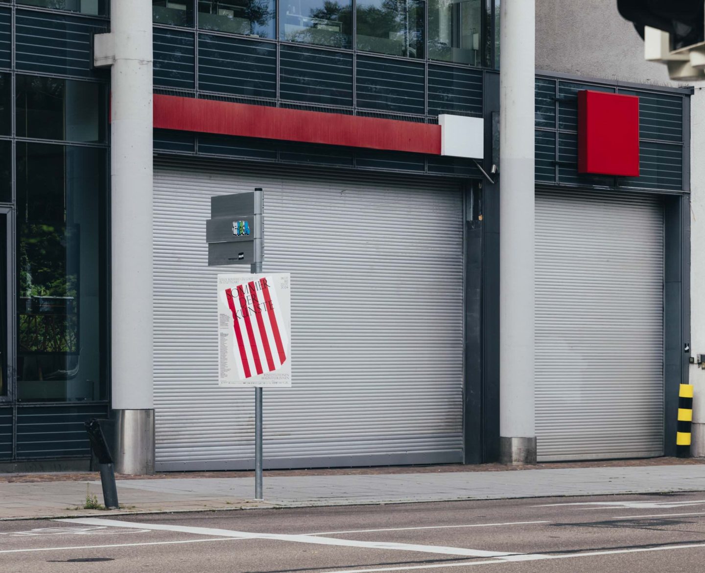 Sommer der Künste poster installed on a street sign in Stuttgart.