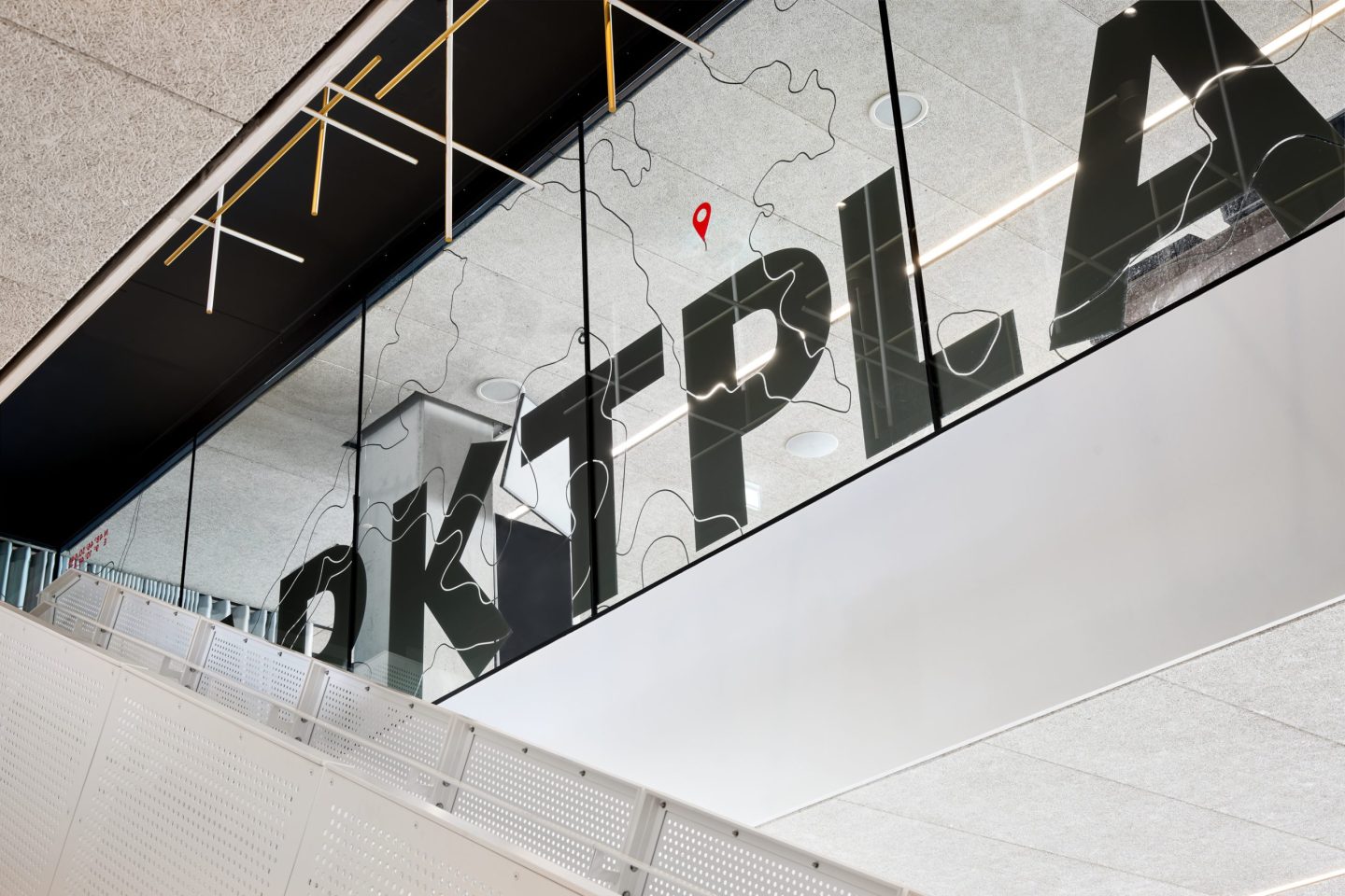 Glass signage for VfB Stuttgart at MHP Arena, featuring oversized “Marktplatz” lettering and a graphic site map applied to the interior window facade.