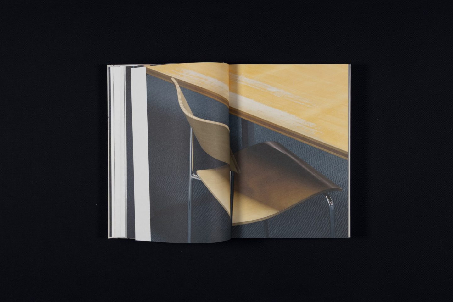 Catalogue spread for Die Schönsten Deutschen Bücher 2025, featuring a full-bleed photographic sequence with a chair and table detail in a minimal editorial layout.
